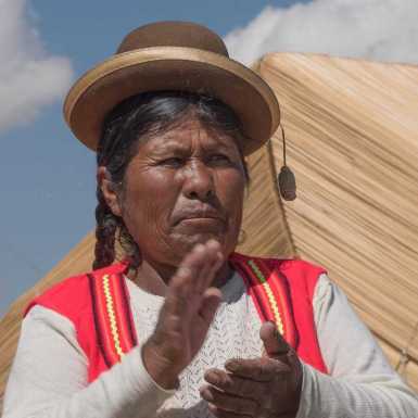 Indigenous Peruvian woman living among the Uru people on floating islands in Lake Titicaca near Puno Peru