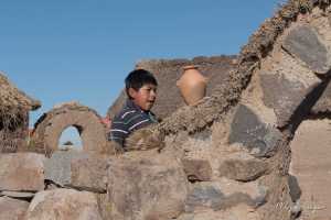 Son of a Peruvian family living in a small house next to Sillustani Peru