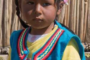 Young girl living among the Uru people on floating islands in Lake Titicaca near Puno Peru