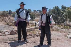 Two authority persons welcoming tourists to the Island of Taquile in Lake Titicaca near Puno Peru